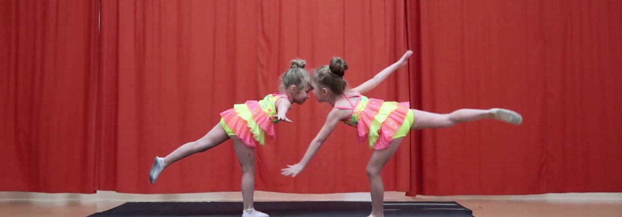 two girls in clothing on a mat